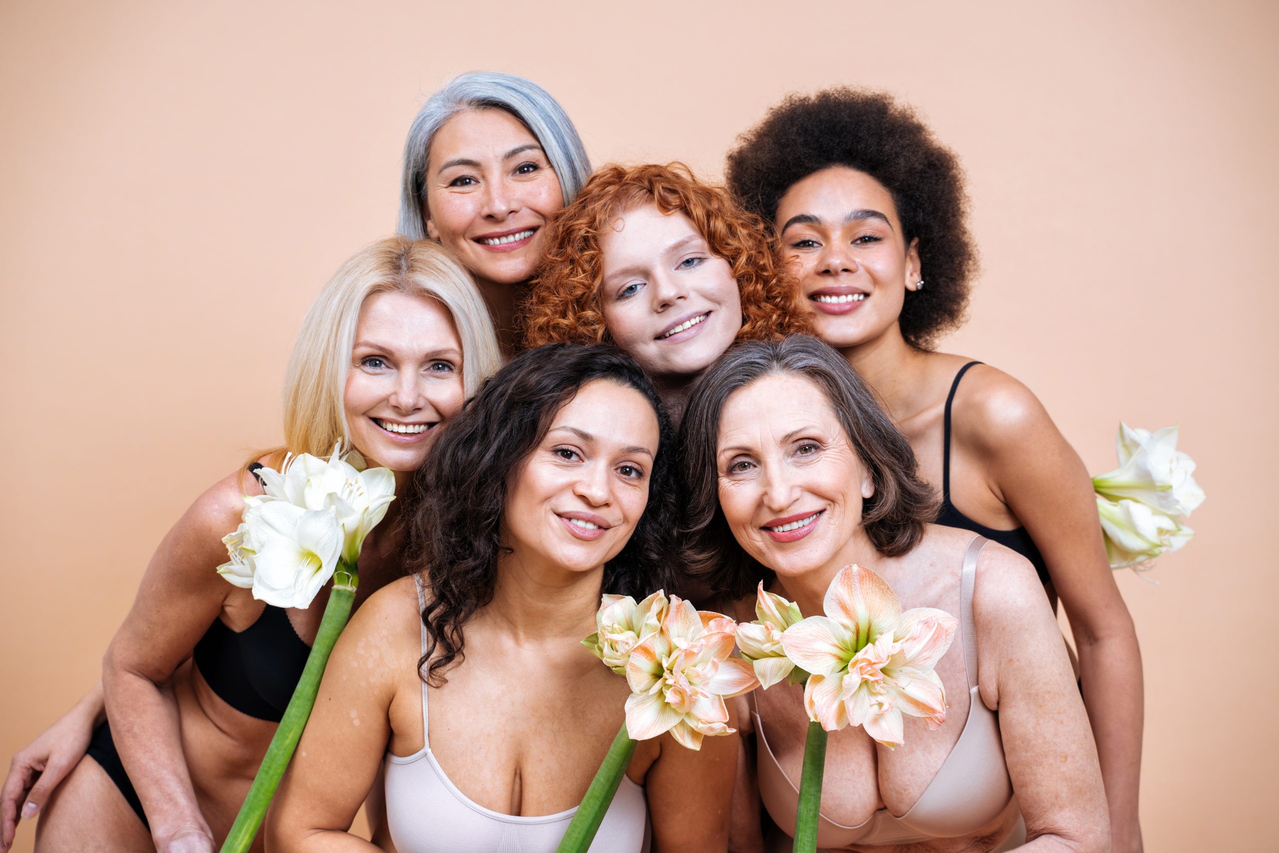 smiling and positive-looking mature women holding flowers